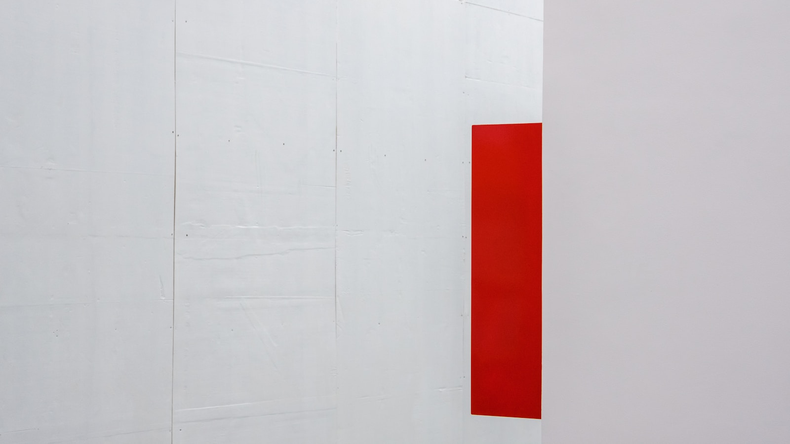 a white wall with a red square on it